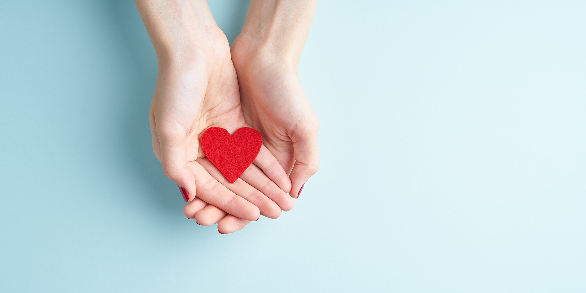 young hands holding or giving a red heart, concept of family and donation or adoption, helth care the medicine concept. hilfe. helfen