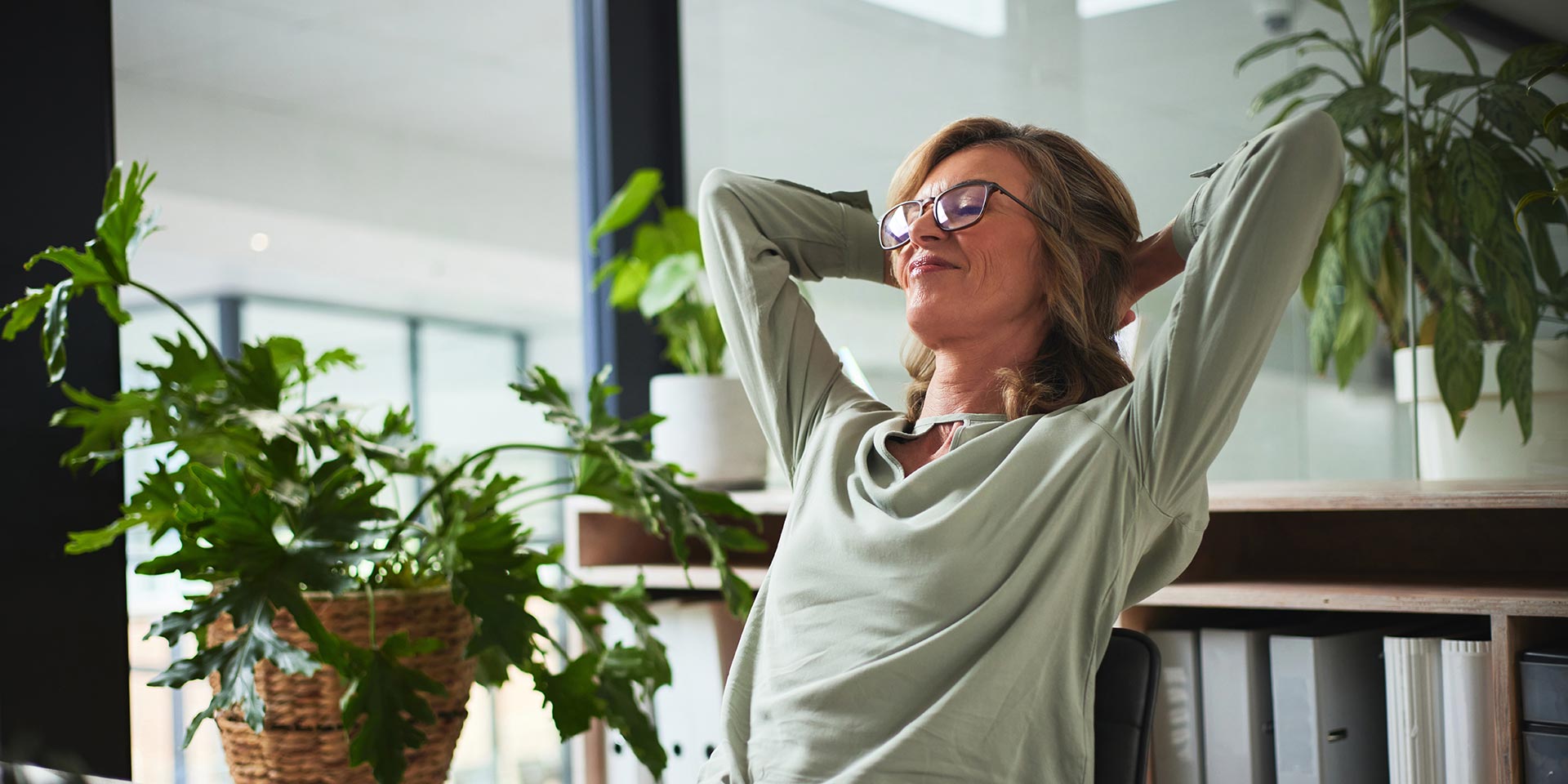 sleep, relax and business man finished with rking on a project in office. success, peace and calm with happy person resting after job complete, hands behind head and stretching for zen in company. symbolbild selfcare