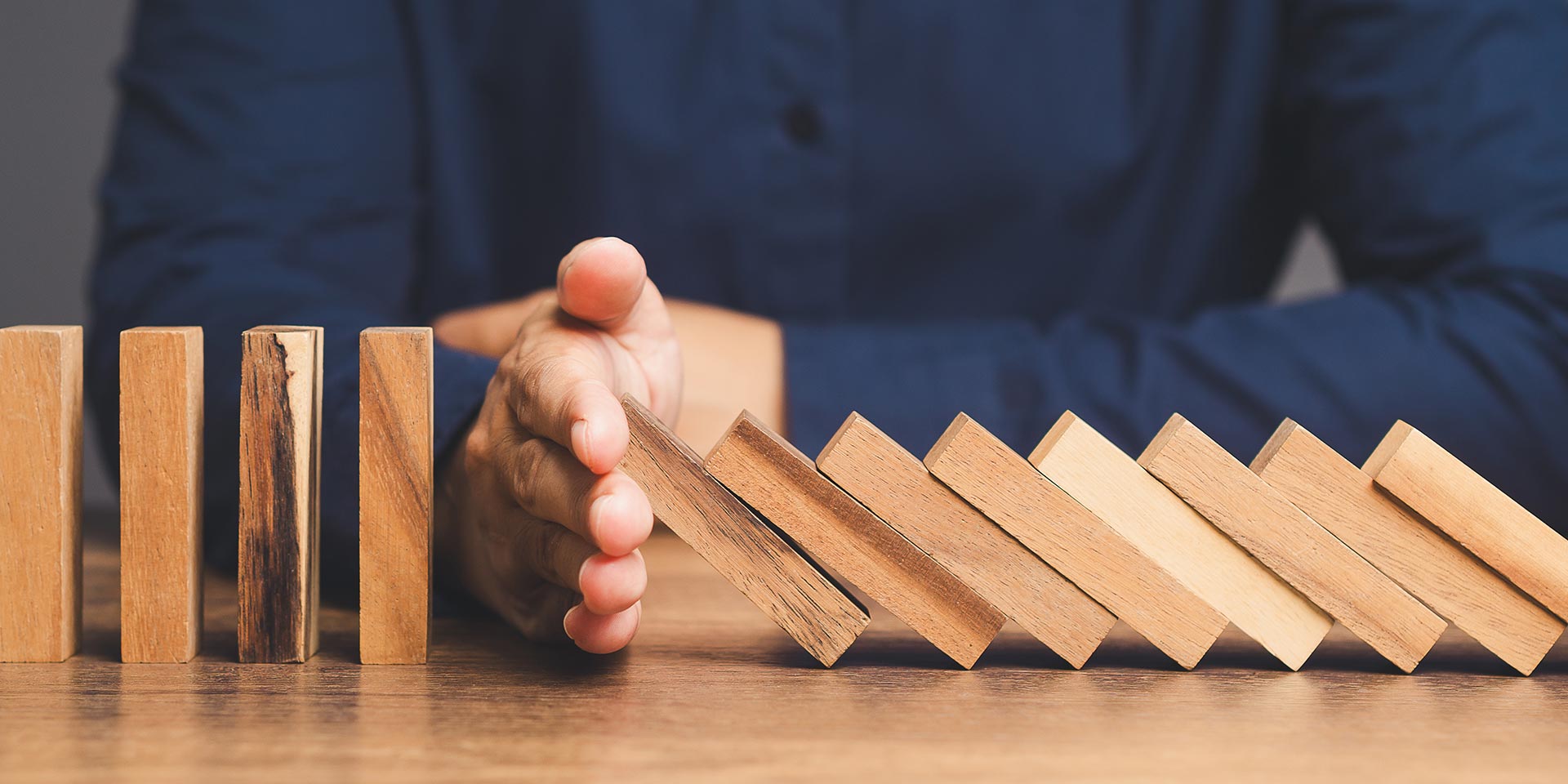 business crisis management. business professionals stop the crisis domino effect, safeguarding against business collapse. prevent business failure through risk management