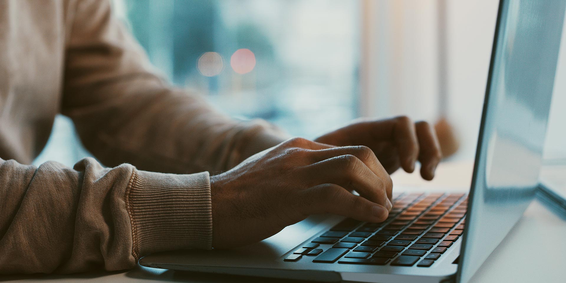shot of an unrecognizable businessman rking on his laptop in the office, nis2