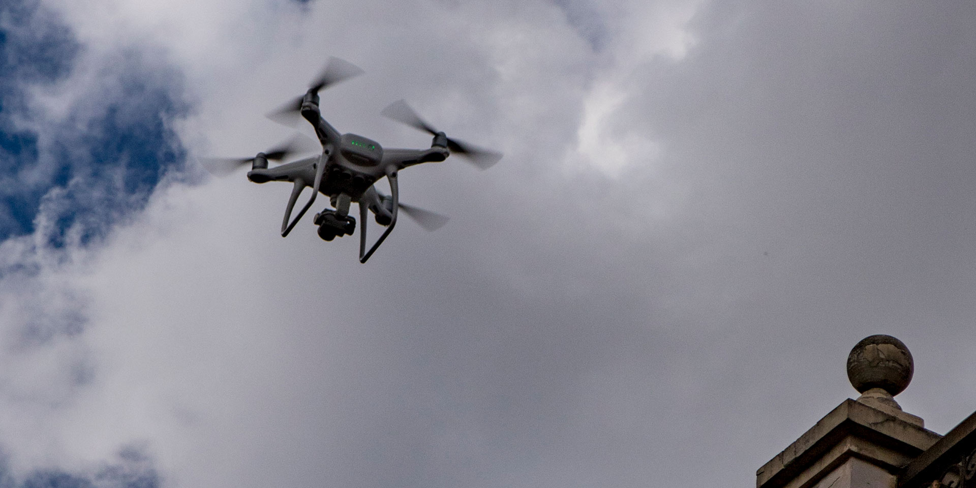 cuenca, ecuador, dec 24, 2017 - drone is seen flying overhead, photographing scene below, drohne