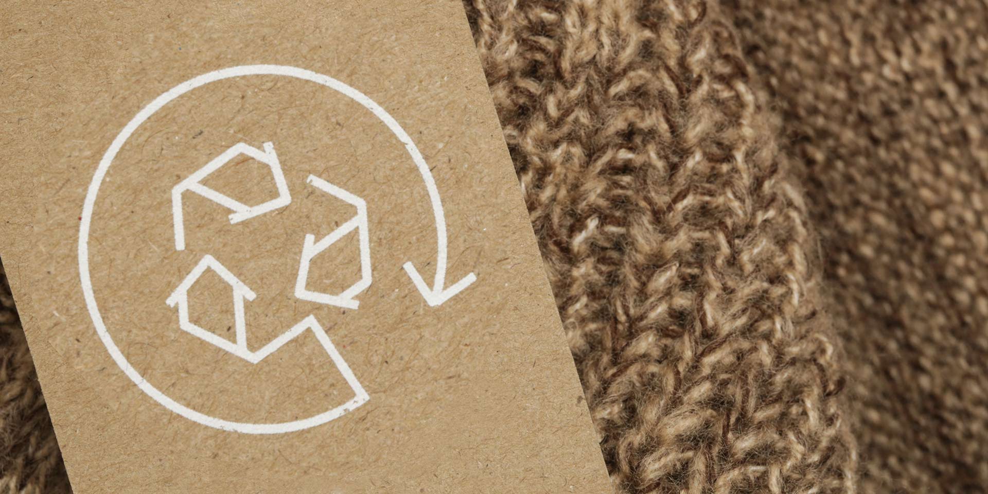 close up of clothing tag with recycle icon. recycling products concept. zero te, suistainale production, environment care and reuse concept. nachhaltigkeit