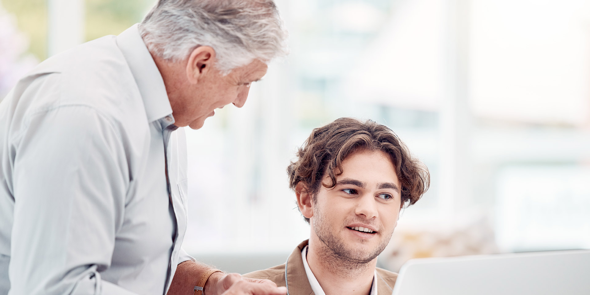 help, coaching and man with manager at computer at tech startup with team lea and quality assurance for staff. businessman, management and leaship helping at creative agency or digital industry, eigentum