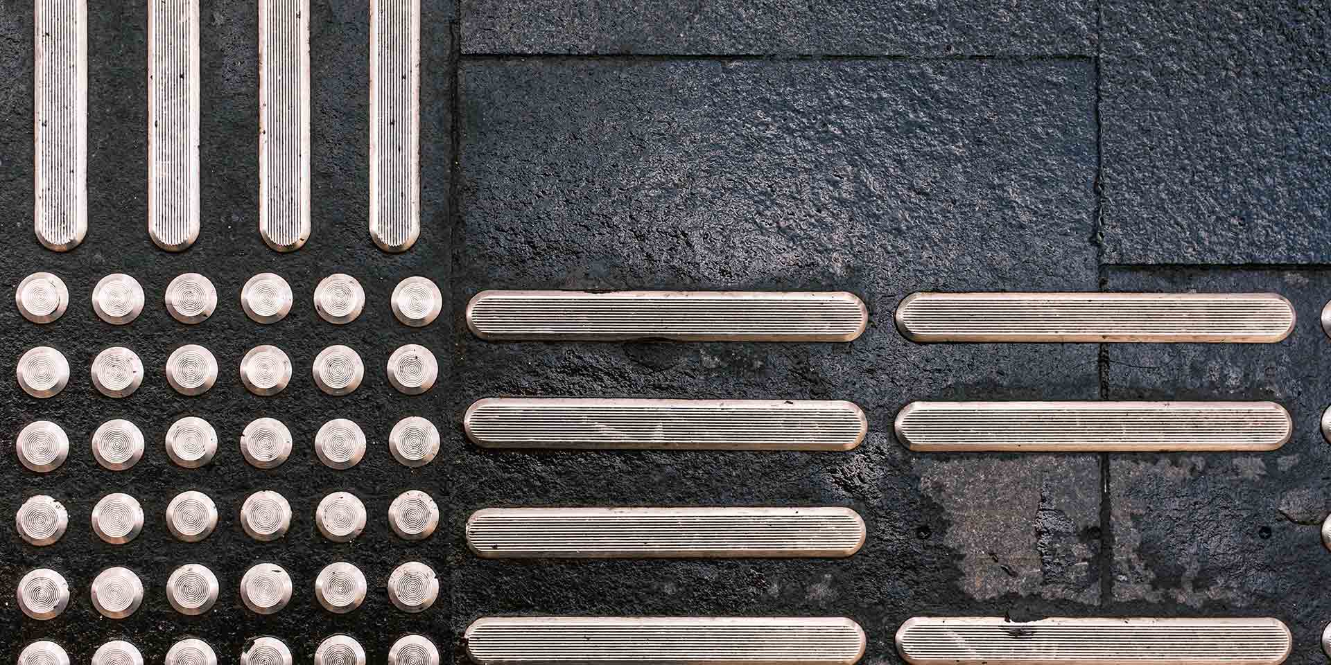 part of the cold quiet geometry series, this image explores industrial repetition and quiet spatial tension in architectural structures. top view of tactile paving blocks designed to guide visually impaired pedestrians. repetitive geometric pattern on urban pavement. inklusion