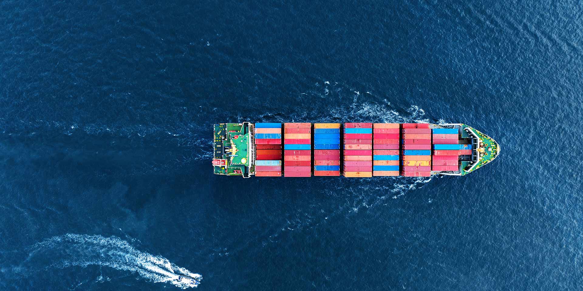 aerial top view of cargo ship carrying container and running with pilot boat for export goods from cargo yard port to custom ocean concept technology transportation logistic tra blobal, supply chain